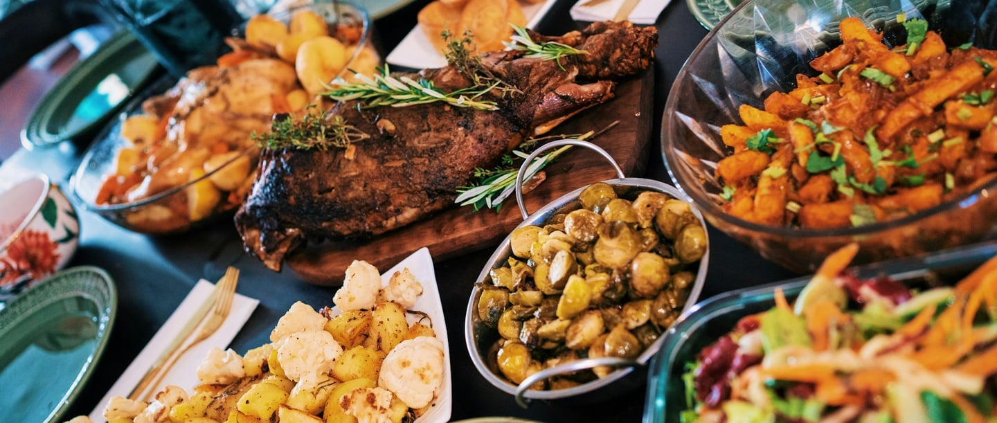 Various dishes and meals on a laid table, beautifully arranged and ready to eat.