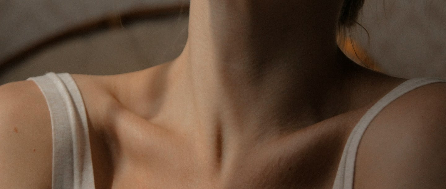 Close-up of a neck and shoulder area, symbolising neck pain after sleeping.