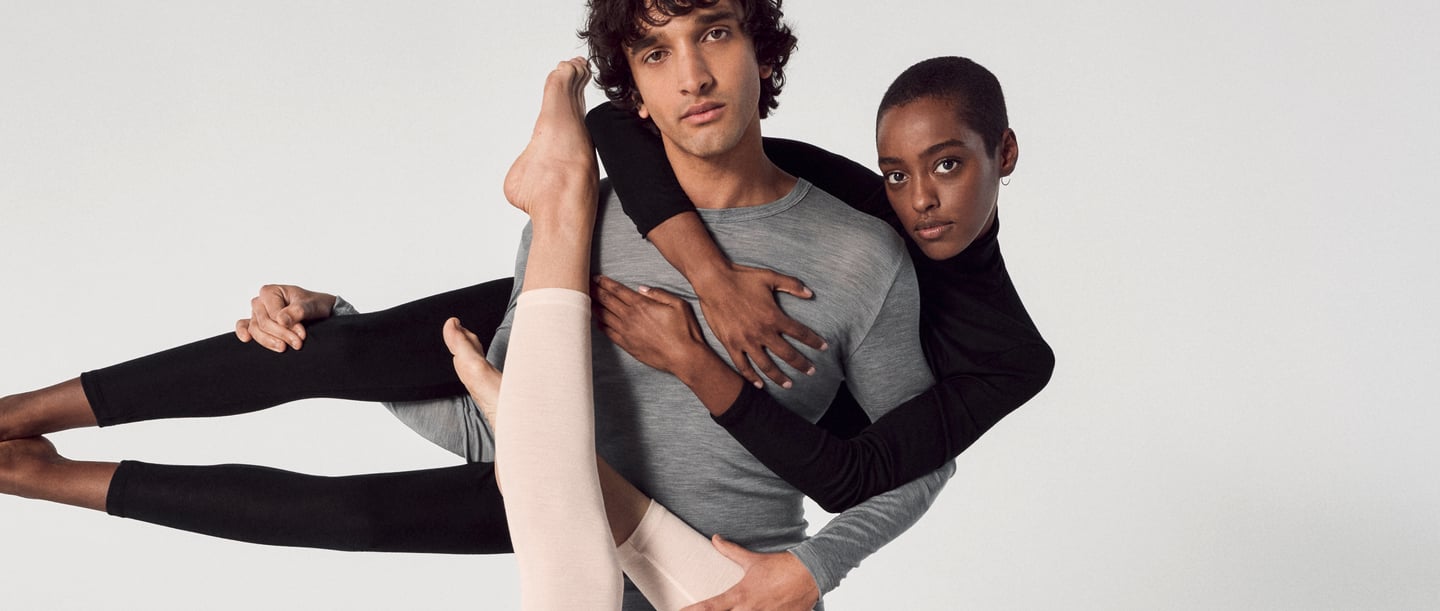 Three people in simple, close-fitting silk outfits pose artfully. The clothes symbolise elegance and comfort - ideal for tips on how to wash silk.