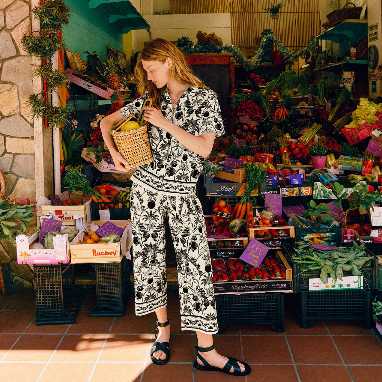 A woman wearing the patterned set of the riviera selection.