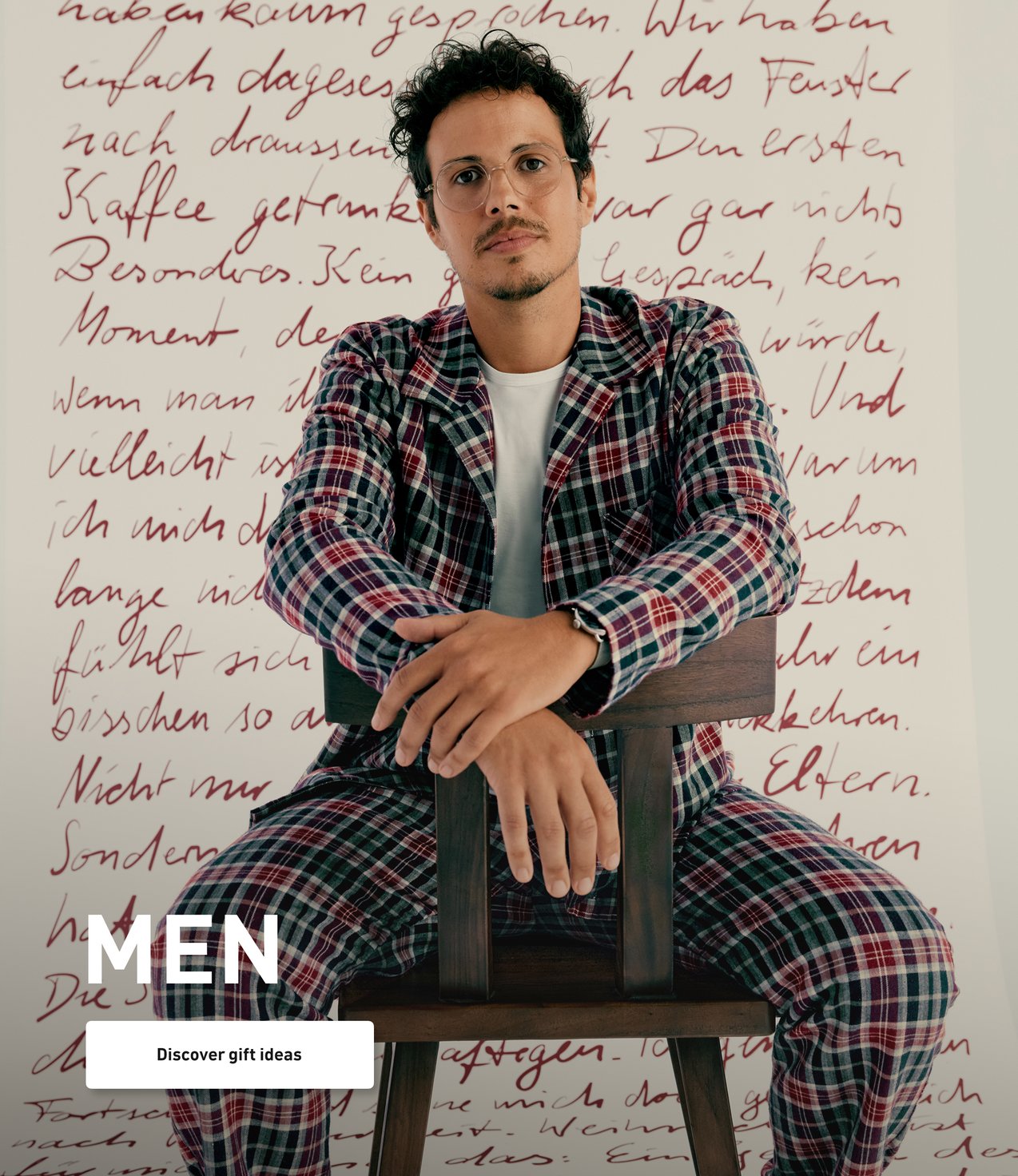 Model wears a checkered flannel pajama in blue and burgundy tones and presents a classic winter look for relaxed nights.