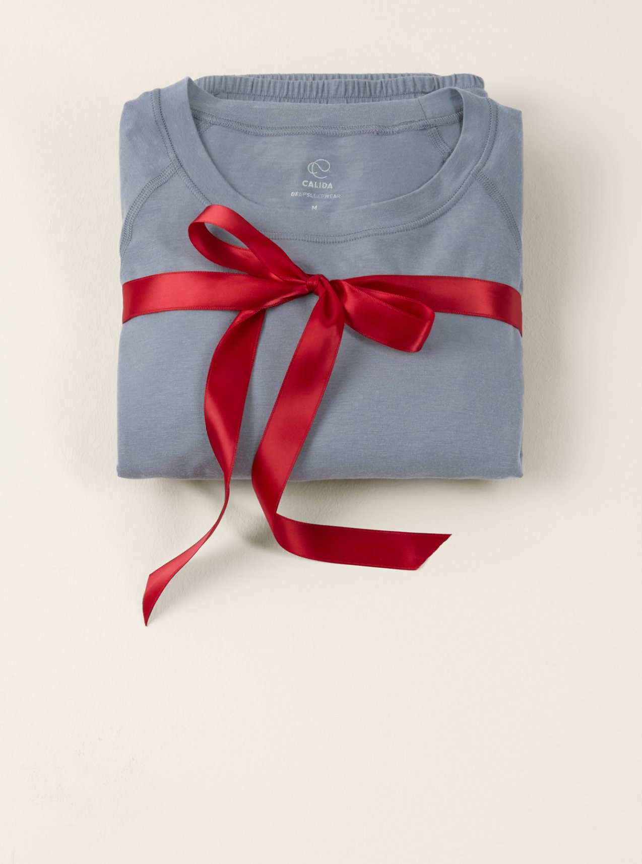 Innovative functional underwear in light blue, presented with a ribbon as a stylish gift idea.