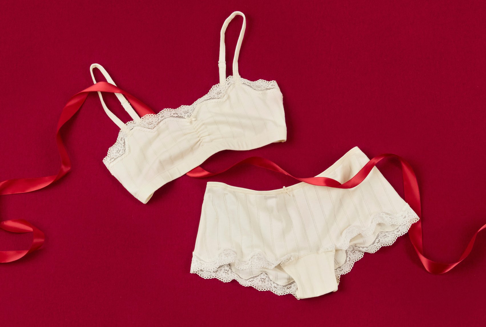 Bustier and shorts with delicate lace details, decorative with ribbon on festive background
