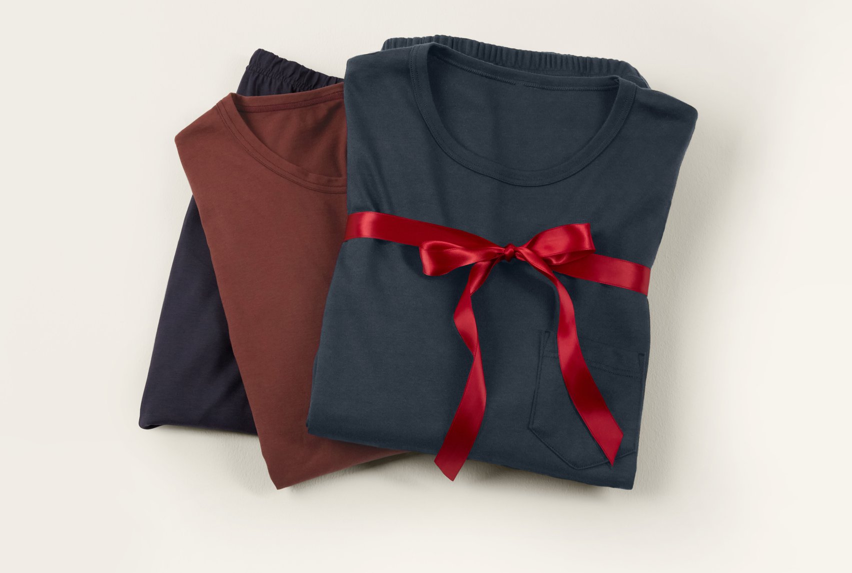 Classic loungewear and nightwear basics made of cotton, arranged with a ribbon as a stylish gift idea.