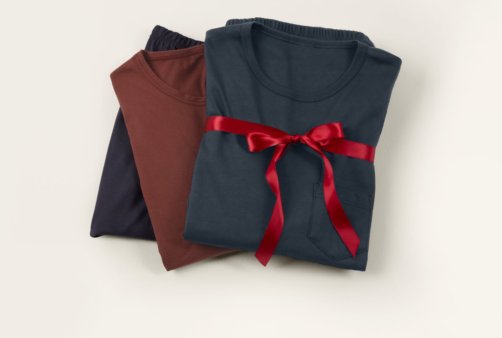 Classic loungewear and nightwear basics made of cotton, arranged with a ribbon as a stylish gift idea.