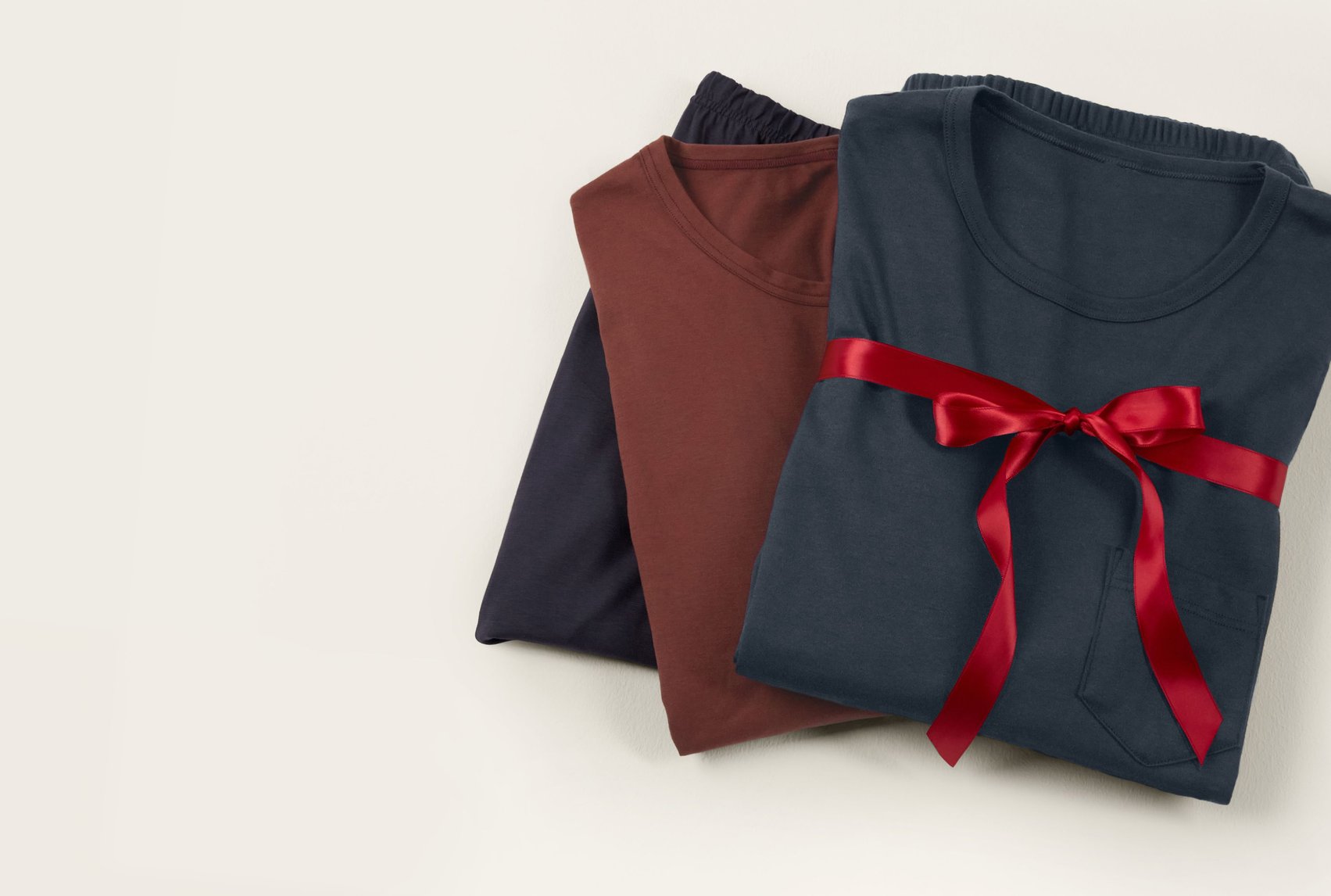 Classic loungewear and nightwear basics made of cotton, arranged with a ribbon as a stylish gift idea.