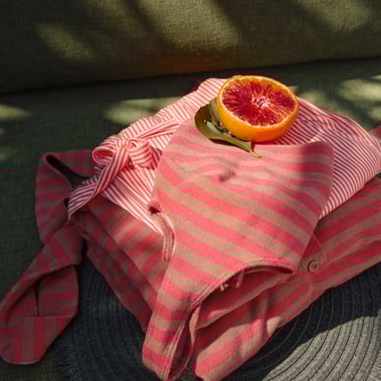 The image shows a display featuring products from the Lounge Stripe and Favourites Beach ranges in pink.