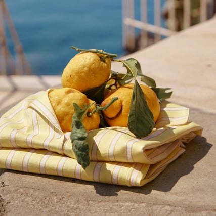 A product shot featuring a yellow and white striped nightwear set from the Favourites Ocean range.