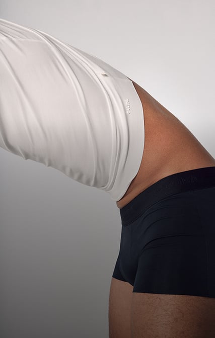 The model is wearing a white T-shirt and boxer briefs with a soft waistband from the Clean Line collection.