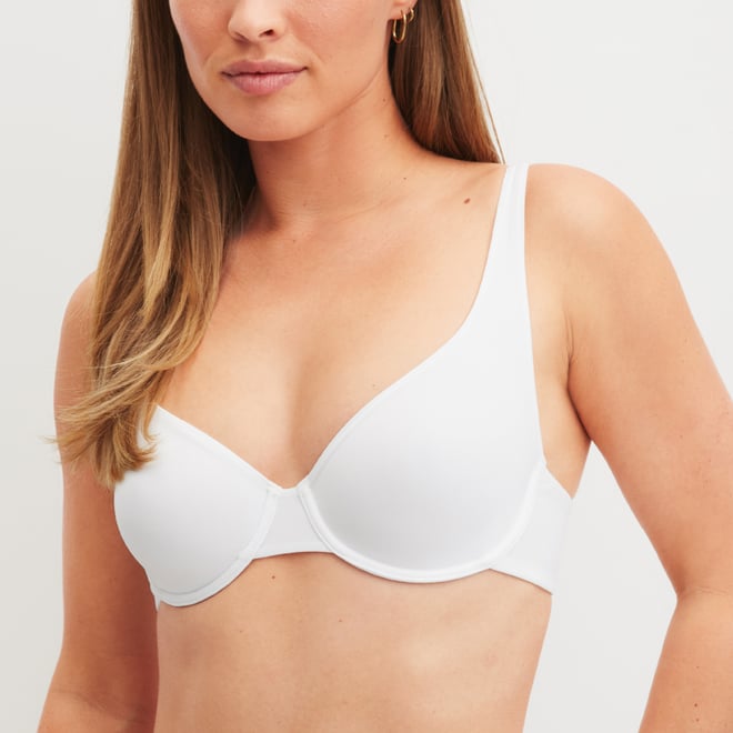 The woman is wearing a underwired bra from the Sleek Skin range in white.
