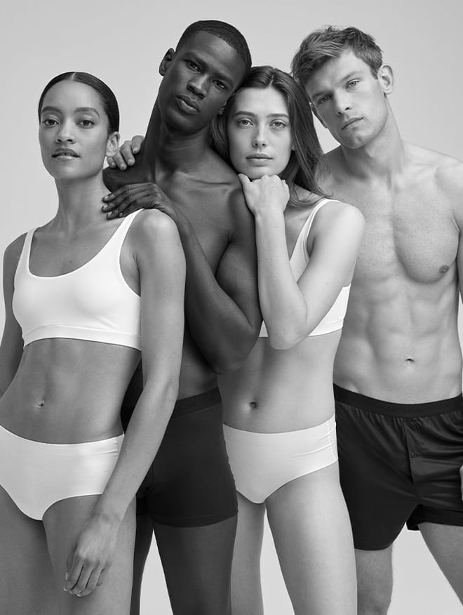Eine Gruppe Frauen und Männer in Calida Unterwäsche in Schwarz Weiß