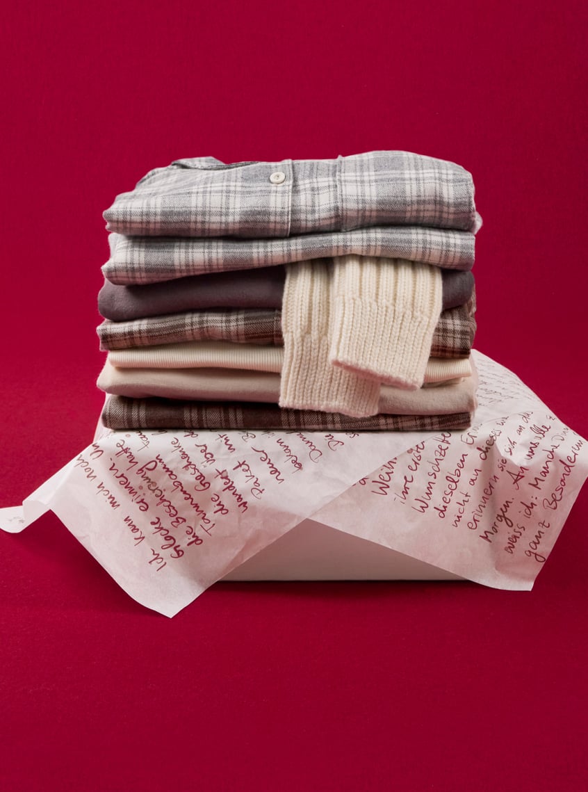 Warming nightwear and homewear in winter materials, decoratively presented as a gift idea.