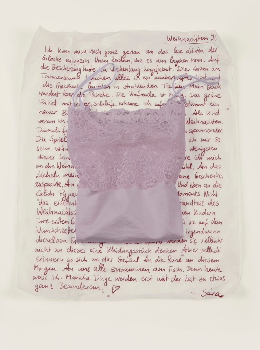 Nightwear with lace in soft pink, arranged as a stylish gift idea.