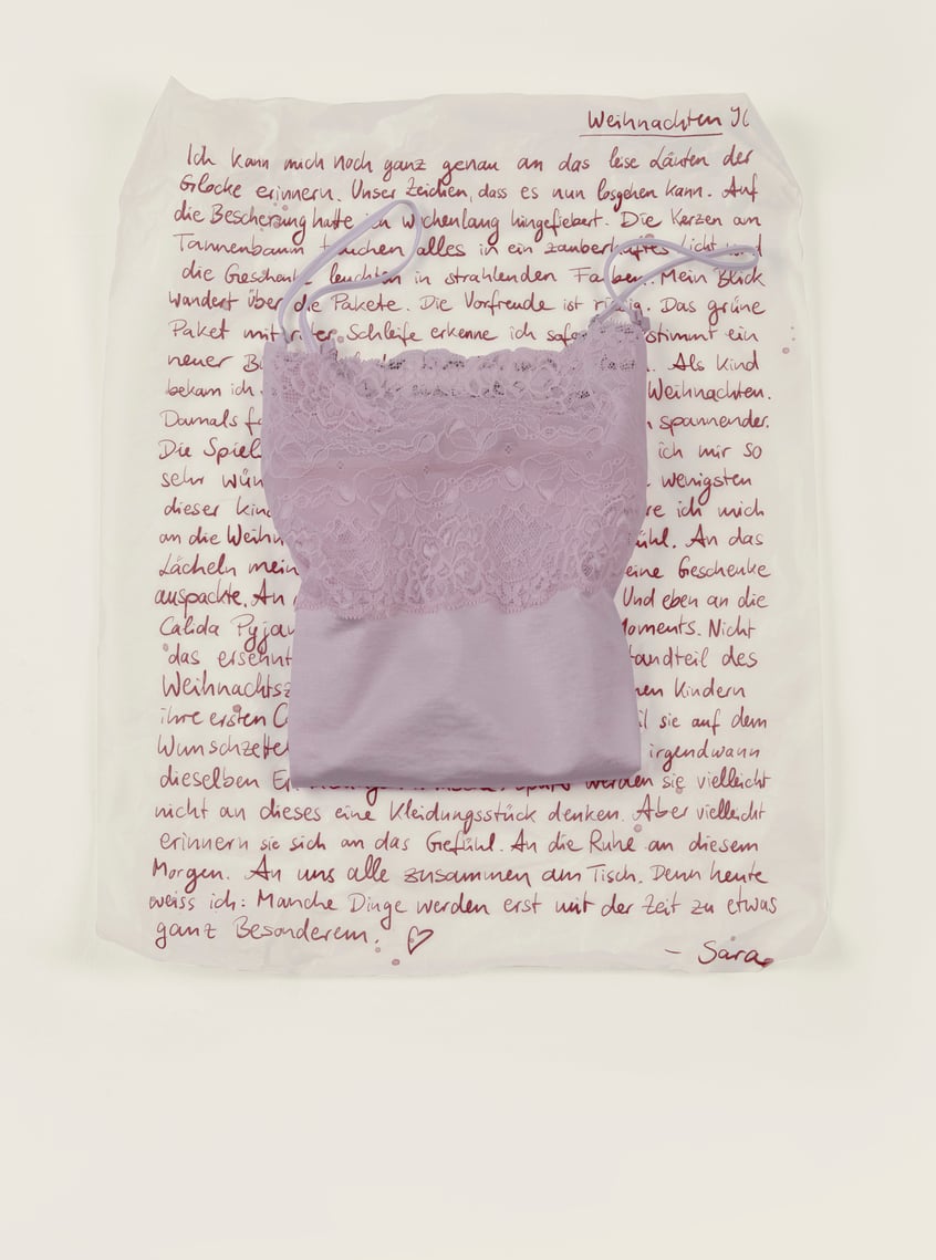 Nightwear with lace in soft pink, arranged as a stylish gift idea.