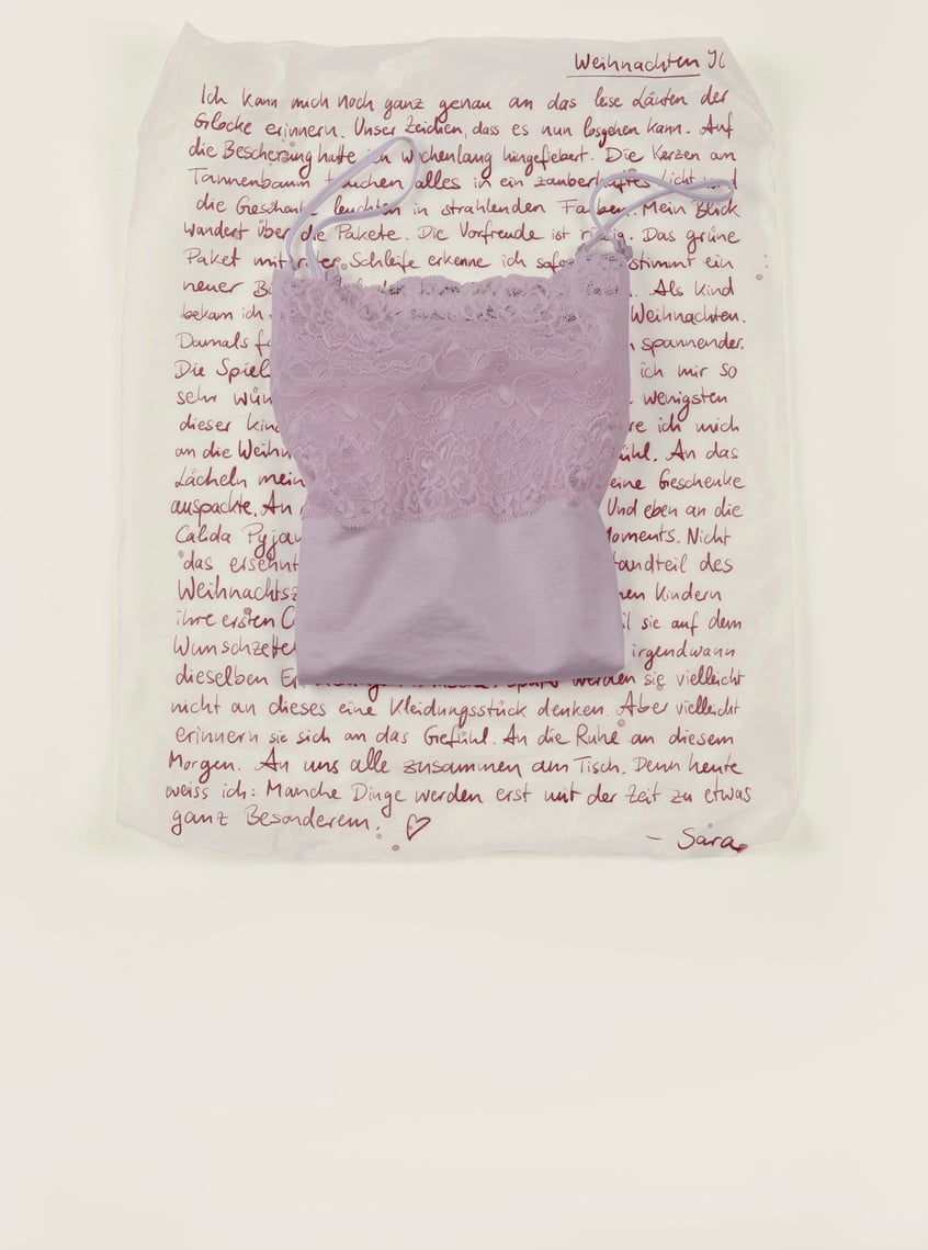 Nightwear with lace in soft pink, arranged as a stylish gift idea.
