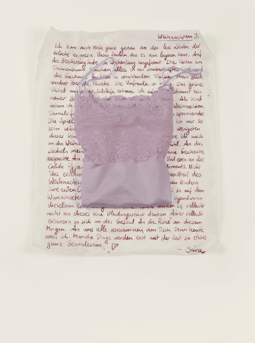 Nightwear with lace in soft pink, arranged as a stylish gift idea.