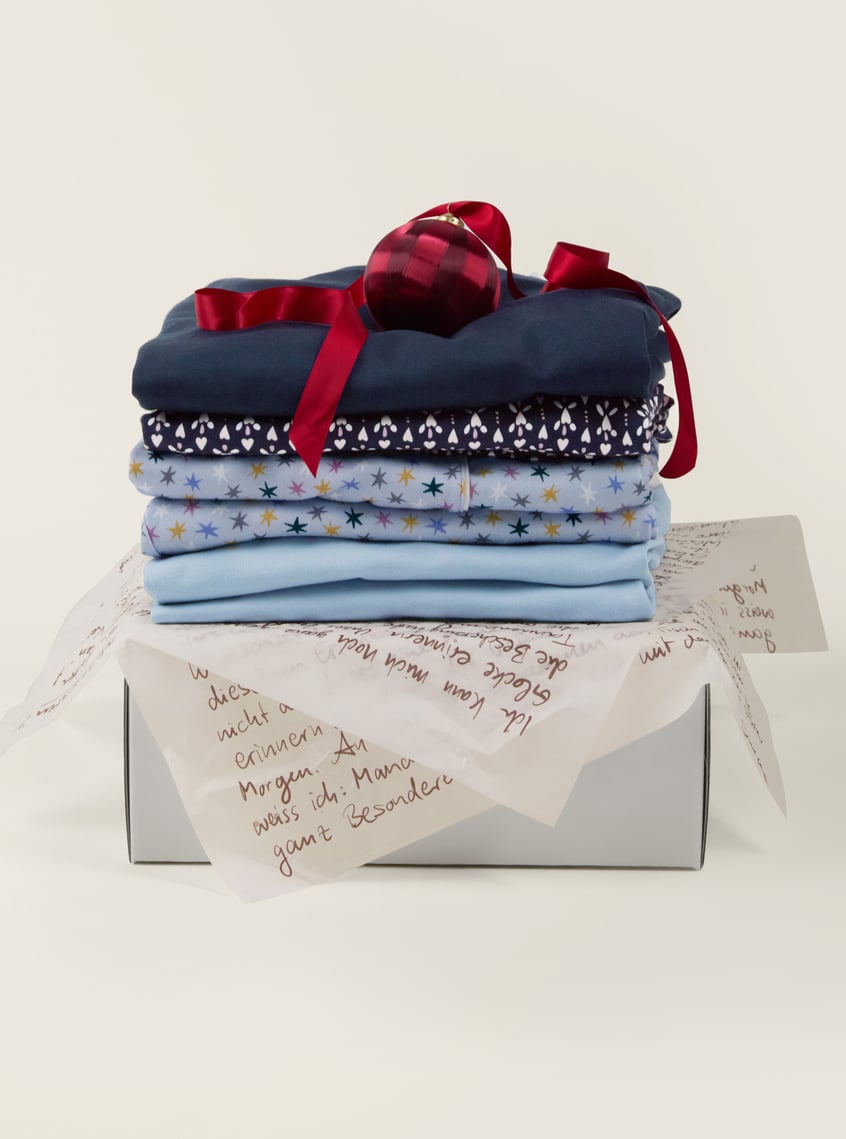 Skin-friendly nightwear with star and print designs, decoratively packaged as a gift set.