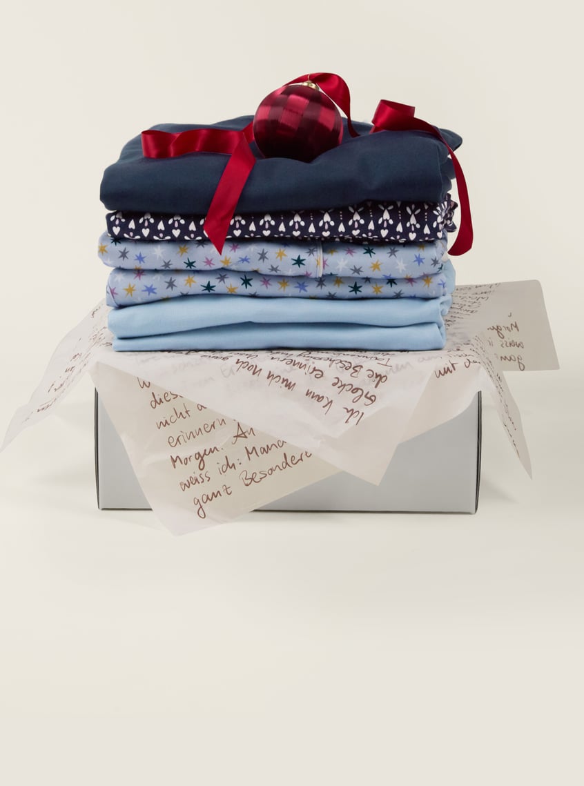 Skin-friendly nightwear with star and print designs, decoratively packaged as a gift set.