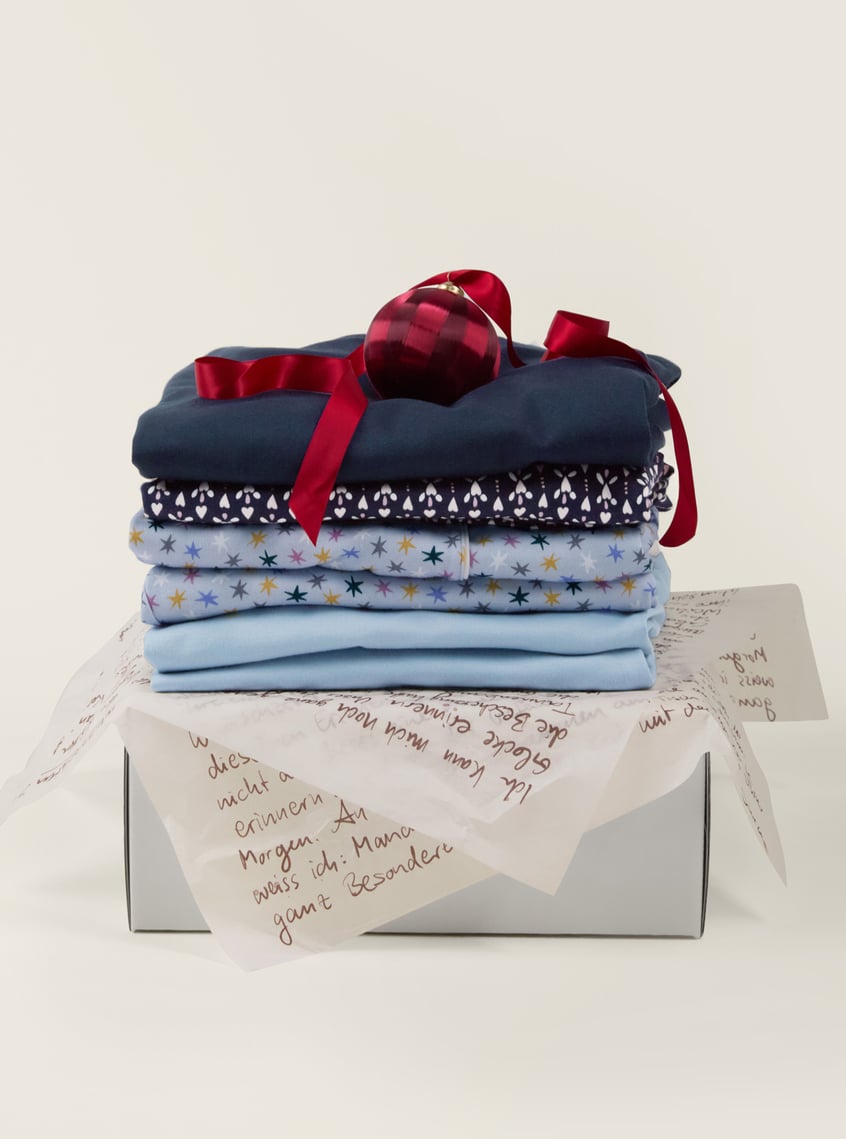 Skin-friendly nightwear with star and print designs, decoratively packaged as a gift set.
