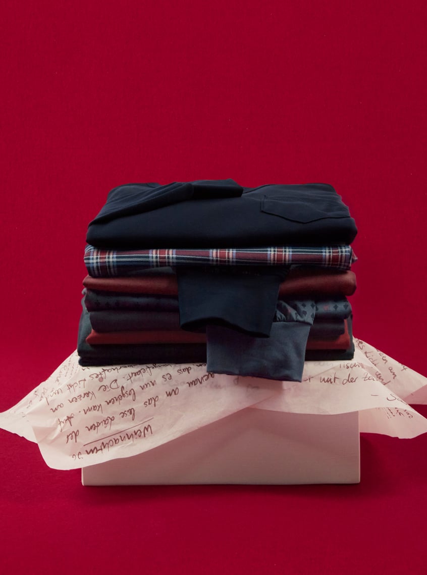 Selection of coordinated nightwear and loungewear sets, stacked and festively presented.