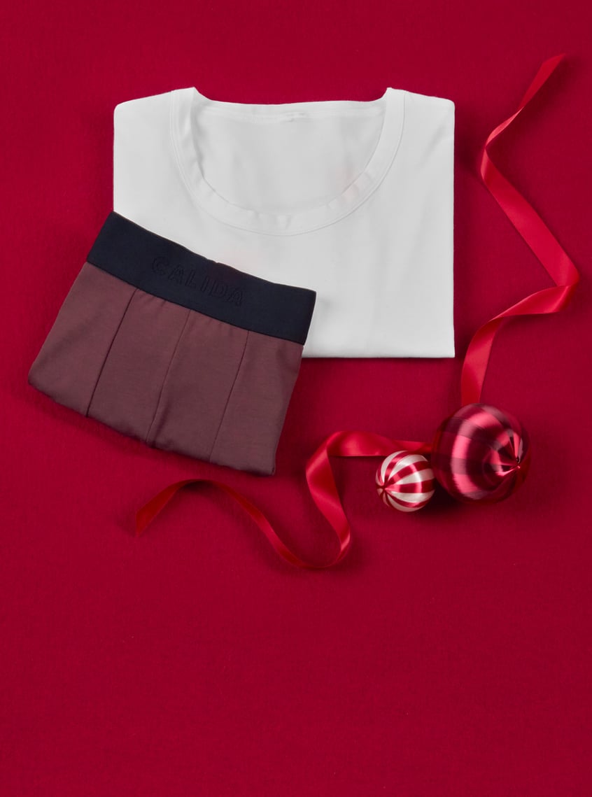White undershirt and boxer shorts in modern colors, arranged as a practical gift idea for everyday life.