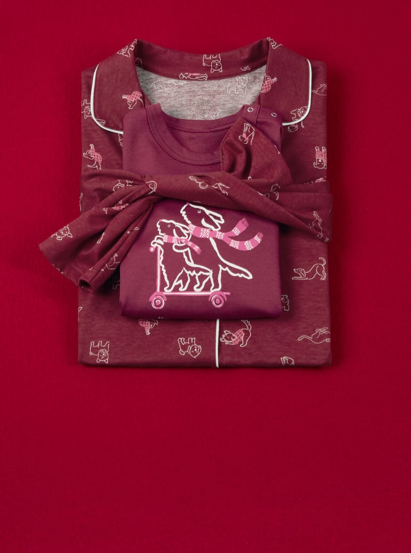 Children's sleepwear with playful all-over print and matching top, decoratively presented as a gift set.