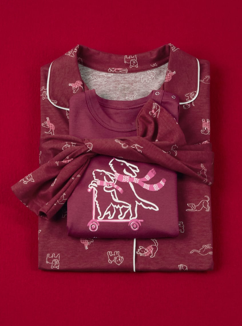Children's sleepwear with playful all-over print and matching top, decoratively presented as a gift set.