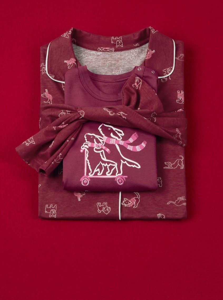 Children's sleepwear with playful all-over print and matching top, decoratively presented as a gift set.