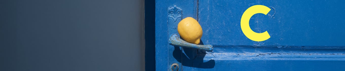 The picture shows a blue door with a lemon resting on the door handle. The yellow ‘C’ for the CALIDA CLUB is also visible.