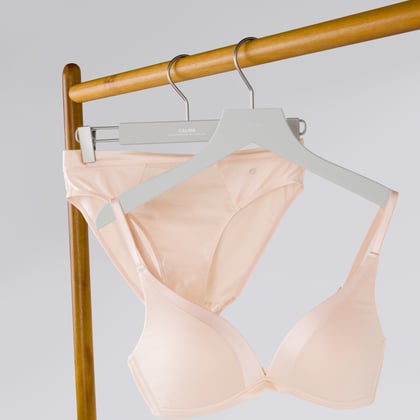 A bra is hanging on a clothes rail.
