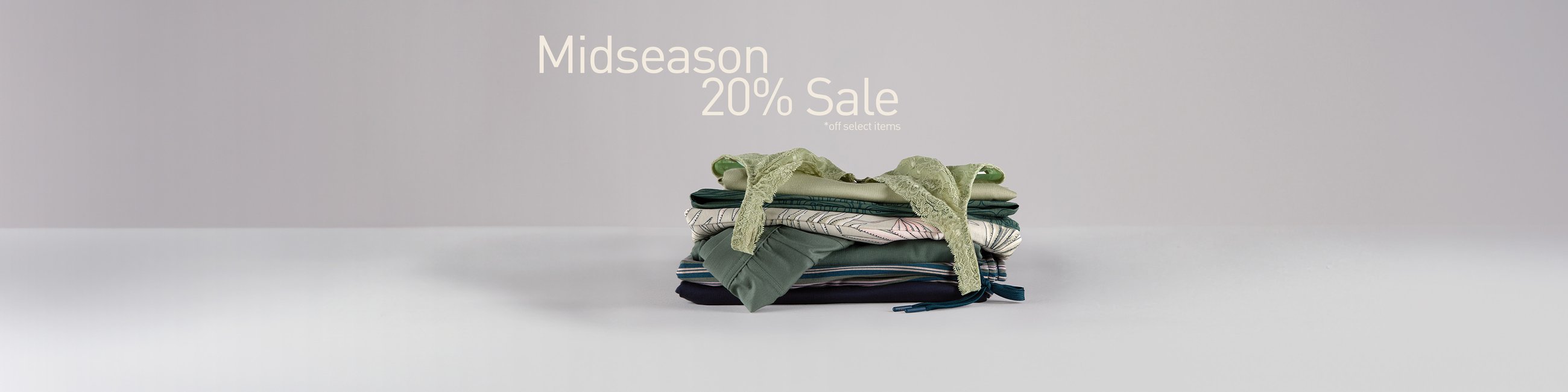 The picture shows a pile of nightwear and underwear. On top is a lace bra.