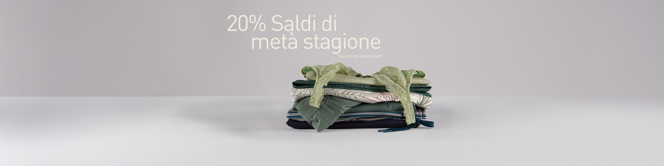 The picture shows a pile of nightwear and underwear. On top is a lace bra.