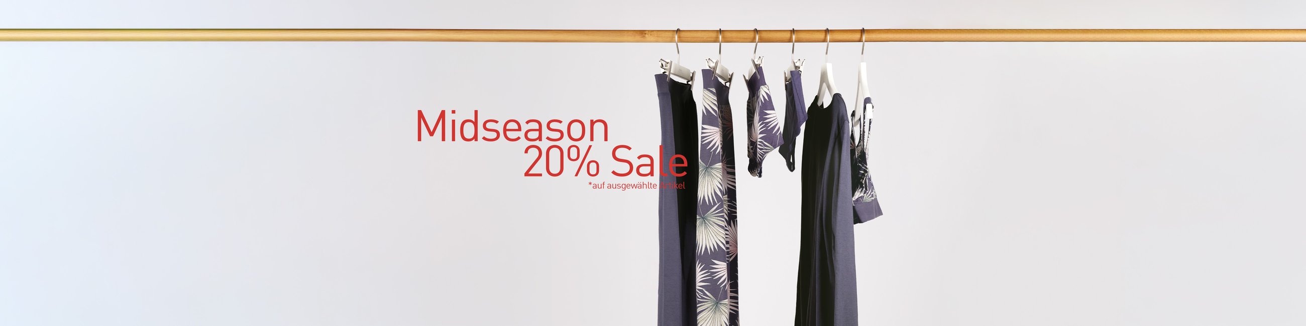 The image shows nightwear and underwear for men and women hanging on a clothes rail.