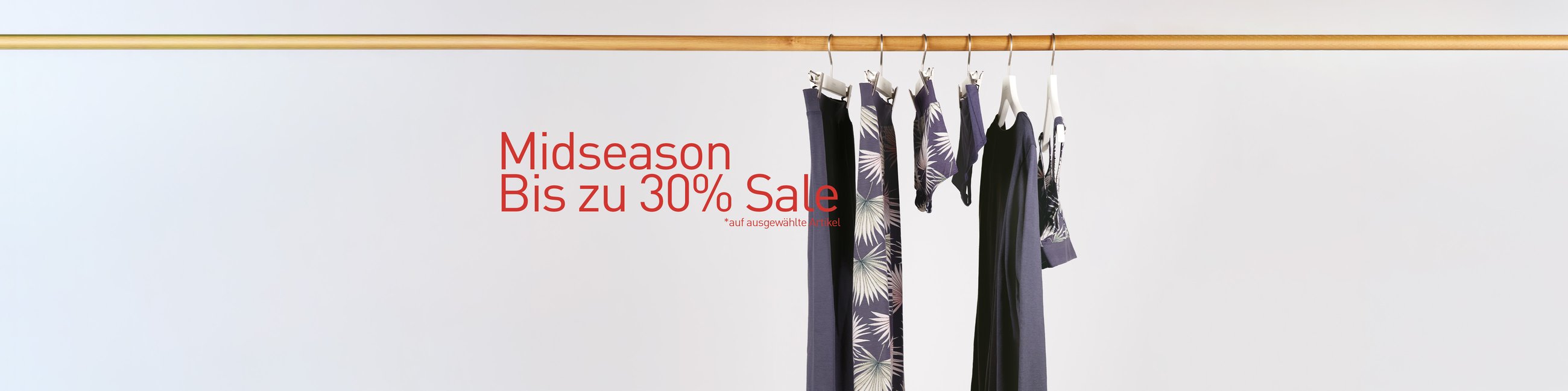 The image shows nightwear and underwear for men and women hanging on a clothes rail.