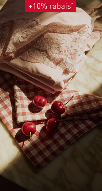 Table with a pyjama on it and cherrys.