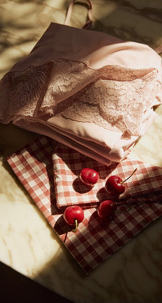 Table with a pyjama on it and cherrys.