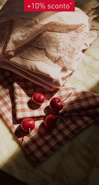Table with a pyjama on it and cherrys.
