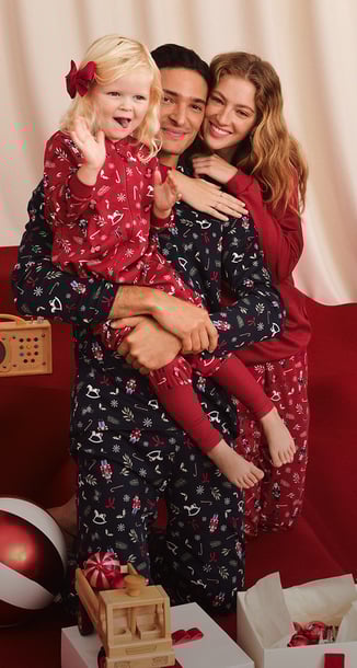 The picture shows a family wearing matching pyjamas with the same pattern.