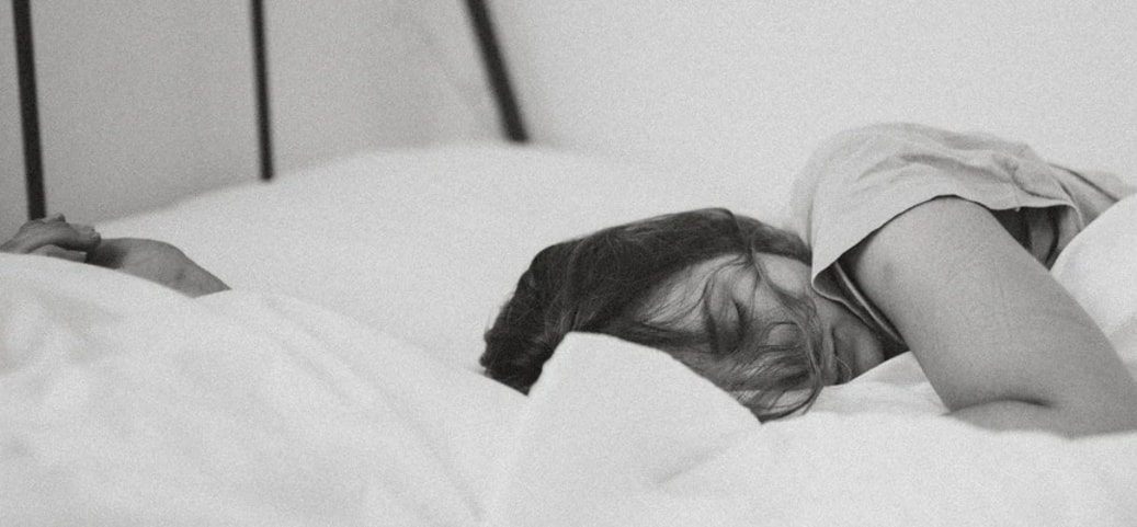 A Picture of a woman in bed asleep