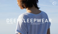 Rear view of a person wearing a light blue DEEPSLEEPWEAR short‑sleeve shirt by the sea, with overlaid text highlighting cooling TENCEL Lyocell sleepwear for menopause.