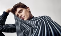 A man with his eyes closed, bending his right arm to support his head and wearing CALIDA nightwear.