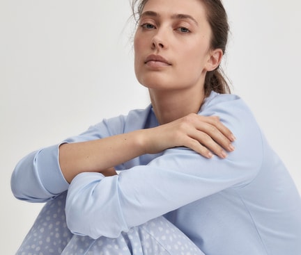 Donna in pigiama azzurro della linea Basic Favourites Sleep di CALIDA su sfondo bianco