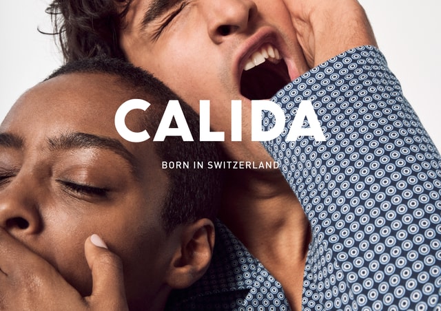 Close-up of two tired people yawning and rubbing their eyes sleepily. The lettering ‘CALIDA - Born in Switzerland’ is placed above the picture.
